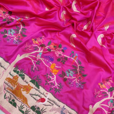 Get mesmerized by the intricate beauty of this pink katan silk Banarasi saree. It features handwoven all over gold zari parrot motifs, multicolour resham meenakari animal and bird motifs, and a skirt paithani border.