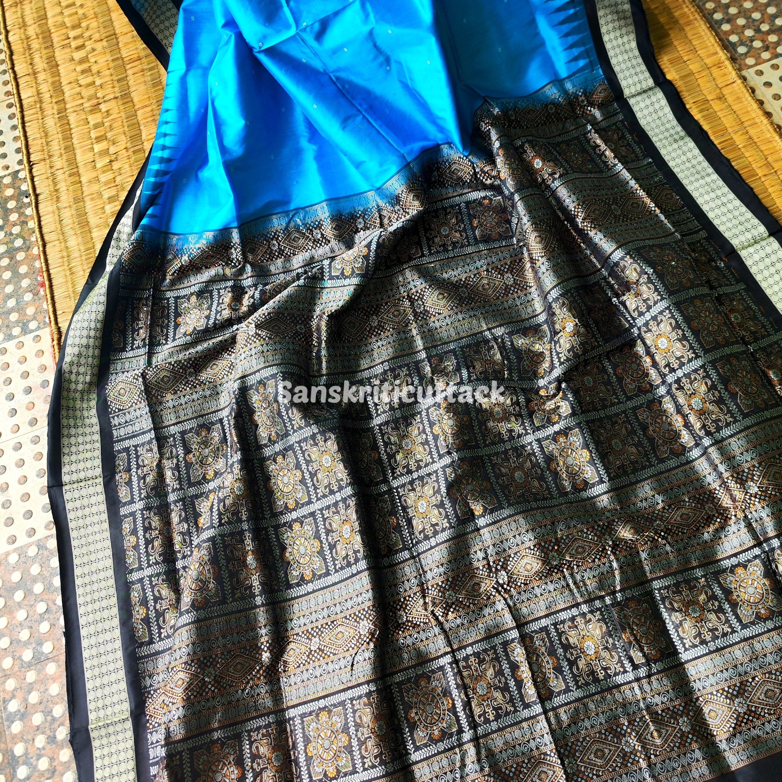 Photo_1731318191854 handloom Bomkai silk saree, traditional Odisha saree, authentic Bomkai silk, Bomkai pata saree, handloom silk saree, Odisha handloom saree, copper sulfate Bomkai saree, saree for special occasions, Bomkai silk saree with blouse, black border saree, elegant handloom saree, silk saree for festive wear, designer Bomkai saree, black pallu Bomkai saree, traditional handloom Bomkai, copper sulfate saree for events, handcrafted Bomkai saree, saree for women, buy Bomkai silk saree, online Bomkai saree shopping, Odisha silk saree, saree with kumbha border, black and copper saree, premium Bomkai saree, wedding Bomkai silk, ethnic wear for women, luxury Bomkai silk