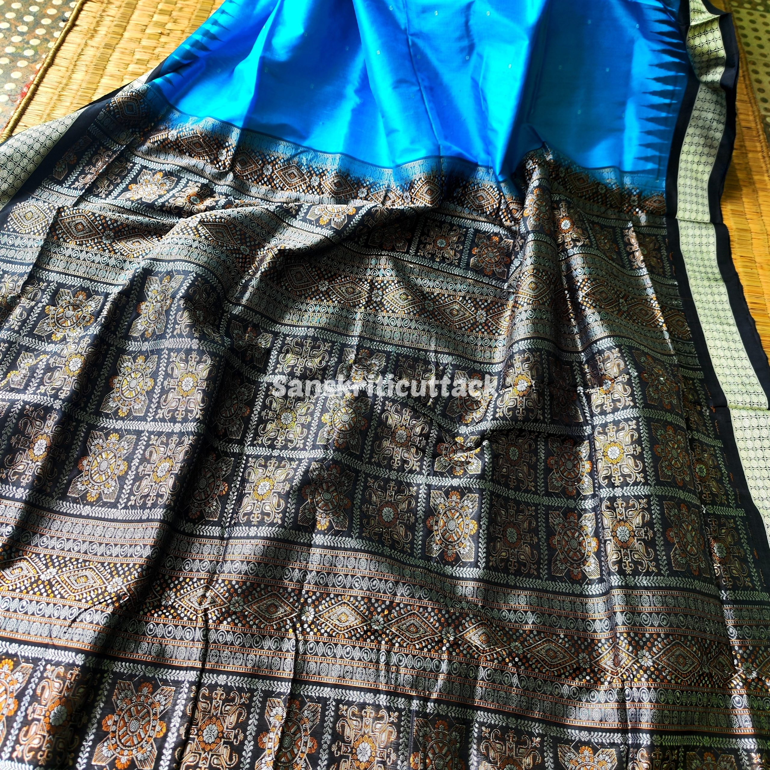 Photo_1731318192808 handloom Bomkai silk saree, traditional Odisha saree, authentic Bomkai silk, Bomkai pata saree, handloom silk saree, Odisha handloom saree, copper sulfate Bomkai saree, saree for special occasions, Bomkai silk saree with blouse, black border saree, elegant handloom saree, silk saree for festive wear, designer Bomkai saree, black pallu Bomkai saree, traditional handloom Bomkai, copper sulfate saree for events, handcrafted Bomkai saree, saree for women, buy Bomkai silk saree, online Bomkai saree shopping, Odisha silk saree, saree with kumbha border, black and copper saree, premium Bomkai saree, wedding Bomkai silk, ethnic wear for women, luxury Bomkai silk