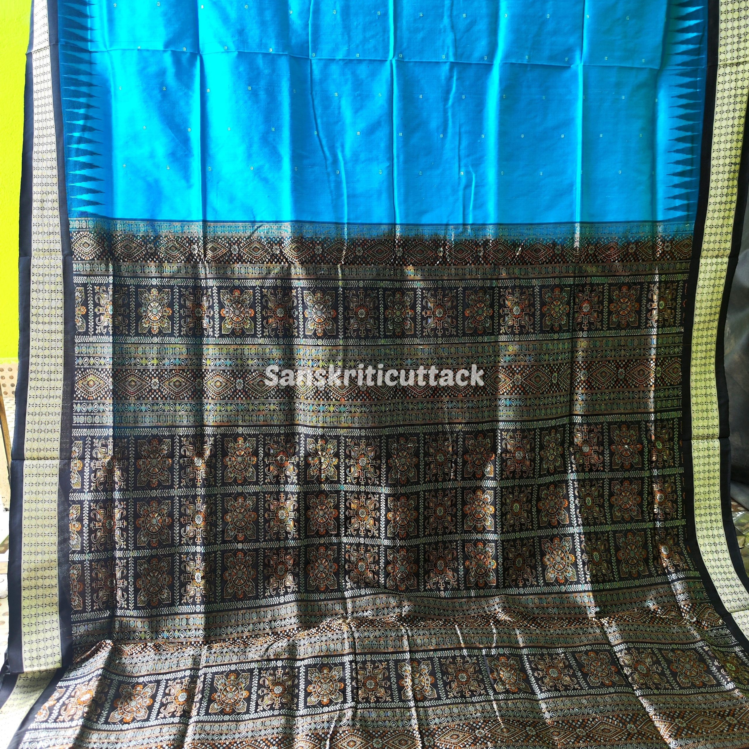 Photo_1731318193344 handloom Bomkai silk saree, traditional Odisha saree, authentic Bomkai silk, Bomkai pata saree, handloom silk saree, Odisha handloom saree, copper sulfate Bomkai saree, saree for special occasions, Bomkai silk saree with blouse, black border saree, elegant handloom saree, silk saree for festive wear, designer Bomkai saree, black pallu Bomkai saree, traditional handloom Bomkai, copper sulfate saree for events, handcrafted Bomkai saree, saree for women, buy Bomkai silk saree, online Bomkai saree shopping, Odisha silk saree, saree with kumbha border, black and copper saree, premium Bomkai saree, wedding Bomkai silk, ethnic wear for women, luxury Bomkai silk