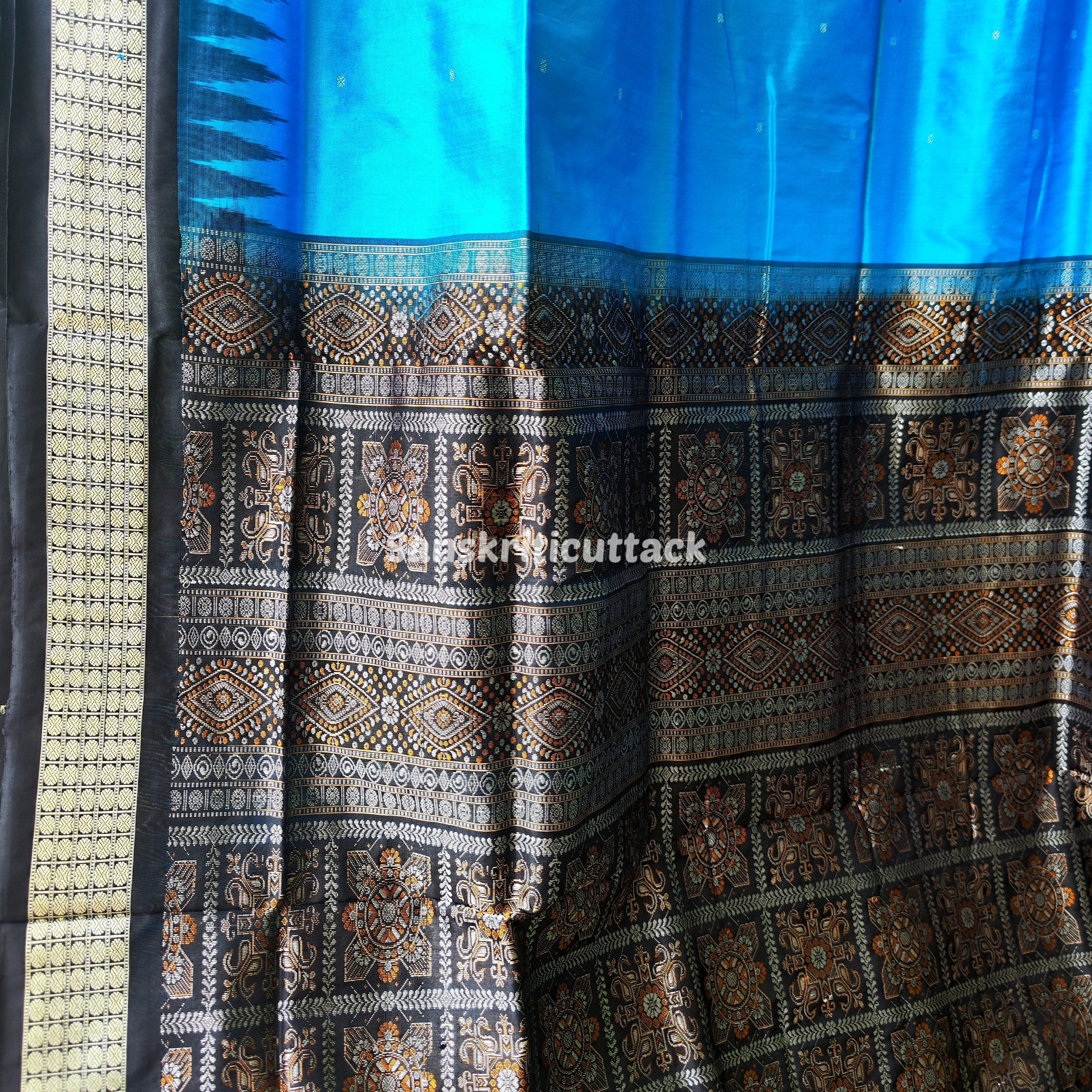 Photo_1731318193872 handloom Bomkai silk saree, traditional Odisha saree, authentic Bomkai silk, Bomkai pata saree, handloom silk saree, Odisha handloom saree, copper sulfate Bomkai saree, saree for special occasions, Bomkai silk saree with blouse, black border saree, elegant handloom saree, silk saree for festive wear, designer Bomkai saree, black pallu Bomkai saree, traditional handloom Bomkai, copper sulfate saree for events, handcrafted Bomkai saree, saree for women, buy Bomkai silk saree, online Bomkai saree shopping, Odisha silk saree, saree with kumbha border, black and copper saree, premium Bomkai saree, wedding Bomkai silk, ethnic wear for women, luxury Bomkai silk